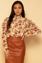 Blusa de tejido elegante con mangas abullonadas y cuello alto falso, estampado floral