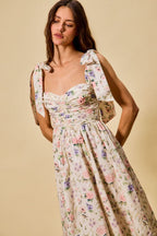 Vestido midi de algodón con corpiño fruncido, estampado floral, con lazo en la parte delantera y forro.