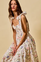 Vestido midi de algodón con corpiño fruncido, estampado floral, con lazo en la parte delantera y forro.